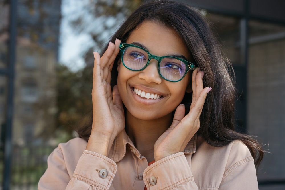 Woman wearing sunglasses doing stop sign - See Breeze Optometry