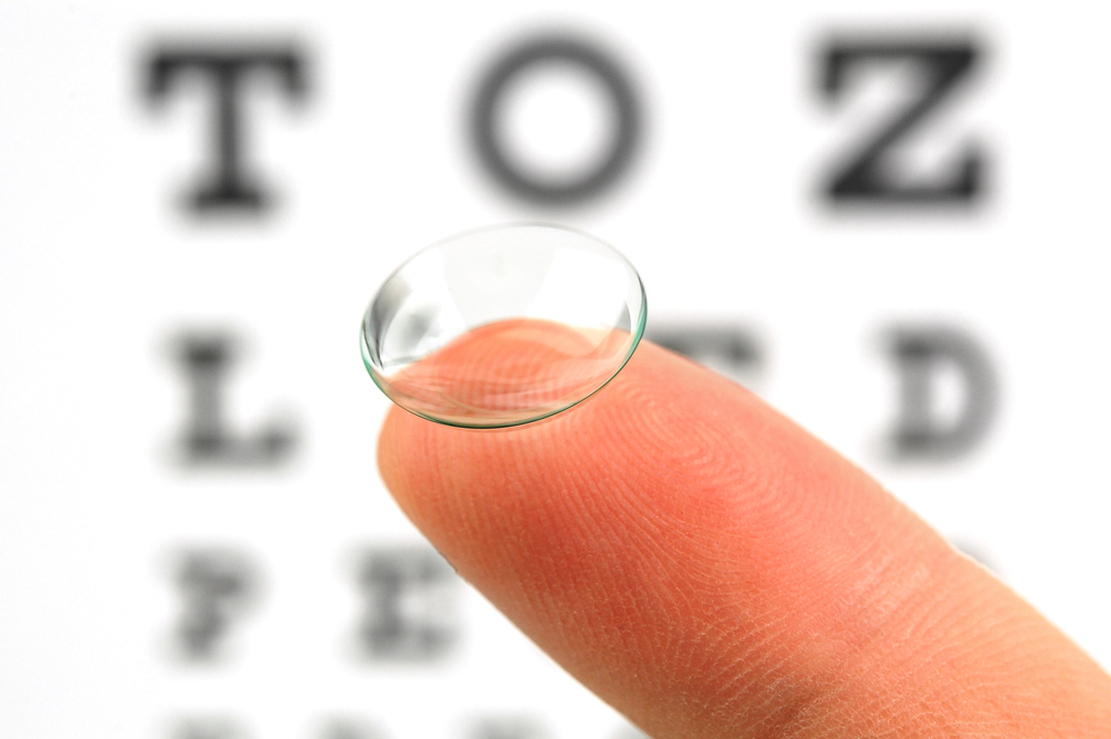 Contact lens on finger and snellen eye chart - Contact Lens Exam Huntington Beach
