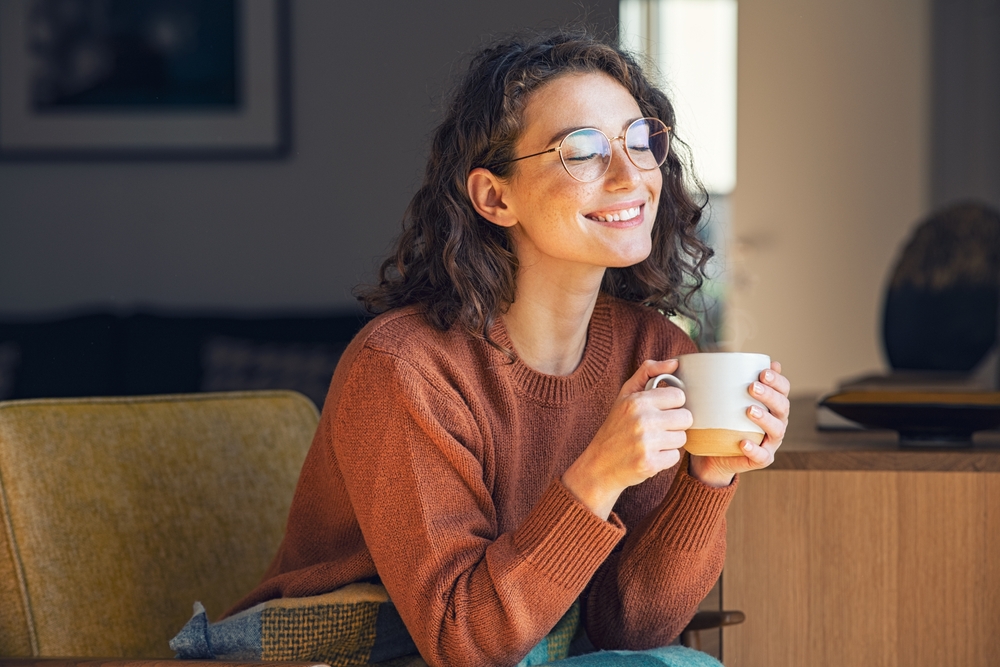 Woman wearing glasses drinking coffee - Myopia Control Huntington Beach