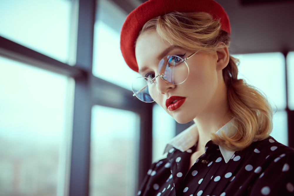 Woman wearing sunglasses doing stop sign - See Breeze Optometry