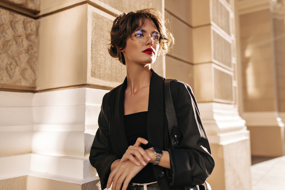 Woman with short hair wearing eye glasses and black blazer looking at the side - See Breeze Optometry Woman with short hair wearing eye glasses and black blazer looking at the side - See Breeze Optometry