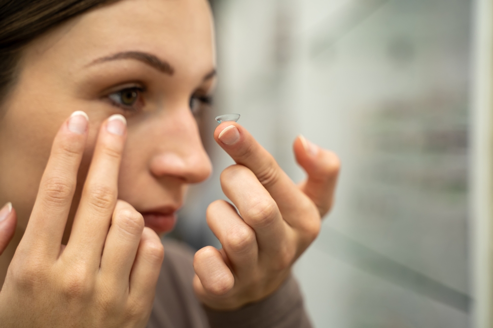 Woman about to wear contact lens - Contact Lens Exam Huntington Beach