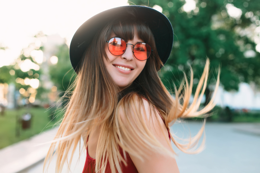 Woman with short hair wearing eye glasses and black blazer looking at the side - See Breeze Optometry